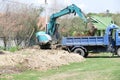 Excavator is loading dirt on truck Royalty Free Stock Photo