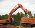 Excavator Loading Dumper Truck Royalty Free Stock Photo