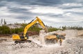 Excavator loading dumpers with blasted stone