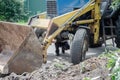 An excavator is loading earth into a dump truck, which is heavy construction equipment on construction site Royalty Free Stock Photo