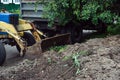 An excavator is loading earth into a dump truck, which is heavy construction equipment on construction site Royalty Free Stock Photo