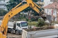 Excavator loading earth in the truck on construction site Royalty Free Stock Photo
