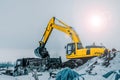 Excavator is loading excavation to the truck. Excavators are heavy construction equipment consisting of a boom, dipper or stick ,
