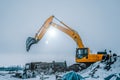 Excavator is loading excavation to the truck. Excavators are heavy construction equipment consisting of a boom, dipper or stick