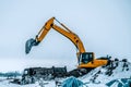 Excavator is loading excavation to the truck. Excavators are heavy construction equipment consisting of a boom, dipper or stick