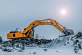 Excavator is loading excavation to the truck. Excavators are heavy construction equipment consisting of a boom, dipper or stick