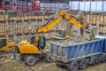 Excavator is loading excavation on the truck. Heavy construction equipment Royalty Free Stock Photo