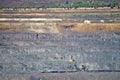 Excavator loading iron ore into goods wagon on the iron ore opencast mine Royalty Free Stock Photo