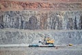 Excavator loading iron ore into goods wagon on the iron ore opencast mine Royalty Free Stock Photo