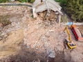 Excavator loading out rubbish and debris into dump truck. demolition site top view