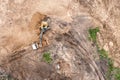 Excavator is loading soil into a dump truck. earthworks on construction site. aerial view from above Royalty Free Stock Photo