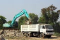 Excavator loading stone dump truck