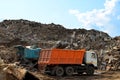 Excavator loads construction waste into reinforced concrete mobile shredder for crushing, recycling of construction mixed waste.