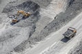 Excavator loads ore into a large mining dump truck. Top view Royalty Free Stock Photo