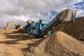 Excavator and machine to pulverize stone in a quarry