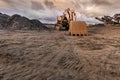 Excavator and machine to pulverize stone in a quarry