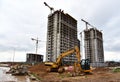 Excavator and mini excavator during excavation and road construction works at construction site. Out of focus, possible