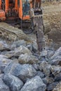 Excavator mounted hydraulic jackhammer used to break up concrete