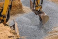 Excavator moving gravel in house under construction Royalty Free Stock Photo