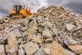 Excavator moving rock in a quarry