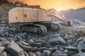 Excavator moving stone and rock at a construction site