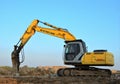 Excavator New Holland E215B with hydraulic breaker hammer for the destruction of concrete and hard rock