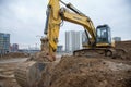 Excavator New Holland E215B working at construction site. Construction machinery for excavation,
