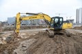 Excavator New Holland E215B working at construction site.