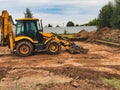 Excavator Operating on Construction Site, Digging and Leveling Soil for New Project Development in an Urban Environment Royalty Free Stock Photo