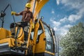 Excavator Operator Standing on His Heavy Duty Machine Royalty Free Stock Photo