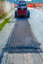 Excavator perform milling of asphalt