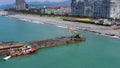 Excavator on a platform in the sea is carrying out repair work