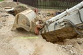 Excavator ploughshare on trench - constructing canalization