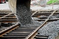 Excavator pours gravel on the tram rails. Repair the road. Urban economy Royalty Free Stock Photo