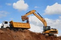 Excavator and rear-end tipper Royalty Free Stock Photo