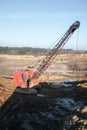 Excavator in the red clay quarry