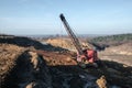 Excavator in the red clay quarry