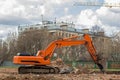 Excavator removes construction waste after building demolition