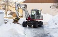 Excavator removing snow