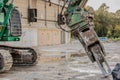 Excavator rips off a building