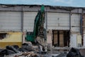 Excavator rips off a building