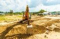 Excavator at sandpit during earthmoving works Royalty Free Stock Photo