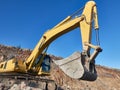 Excavator scoop during road construction on the rocky soils Royalty Free Stock Photo