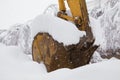 Excavator shovel covered with snow