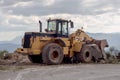 The excavator single-bucket parked by the road