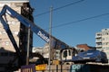 Excavator sitting on a construction site with a half demolished apartment block