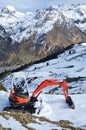 Excavator on the snowy slope Royalty Free Stock Photo