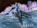 Excavator standing in sandpit with raised bucket over trees on hill Royalty Free Stock Photo