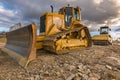 Excavator and steamroller work in the realization of a road