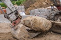 Excavator with stone on excavator bucket